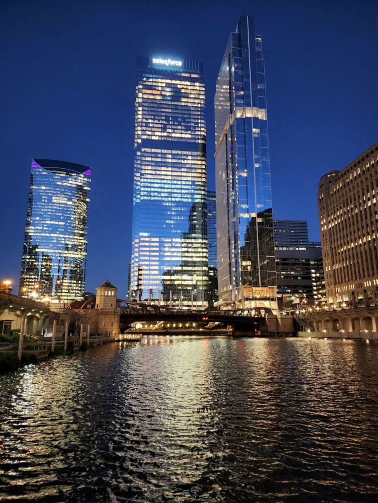 Photo of downtown Chicago with skyscrapers and the Chicago River in the foreground.